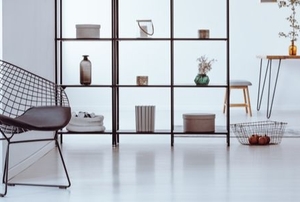 spare minimalist living space with metal chair and shelf affordable furniture