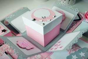 a layered birthday box in pink, white, and gray paper