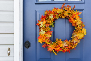 A fall wreath on a blue door.