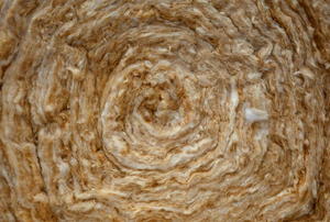 A close-up of the end of a roll of insulation.