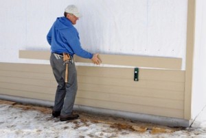 man installing siding