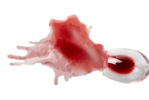 A red wine spill on a thin, white fabric.