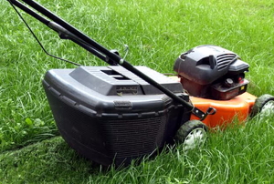 A lawnmower cutting grass. 
