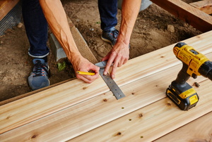 A man works on a deck.