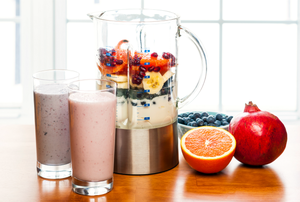 A blender with fruit and yogurt inside for smoothies.