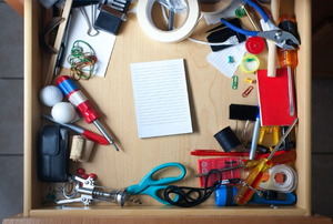 A junk drawer in a kitchen table.