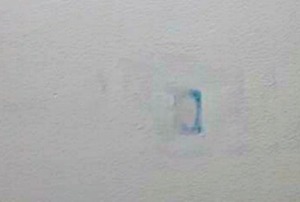An old repair showing through new paint.