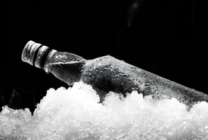 A bottle sitting in ice. 