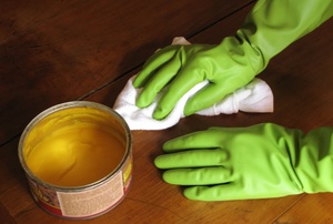 Removing wax from a wood floor.