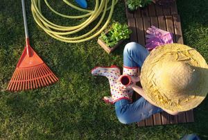 A woman taking a coffee break in her garden.