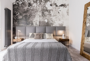 small space bedroom with large mirror and gray art design on wall