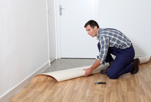 A man works with linoleum floors.