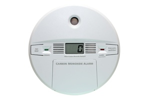 A white digital carbon monoxide detector.