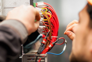 electrician working with red wires