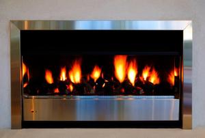 A fireplace wall unit, with a fire lit.