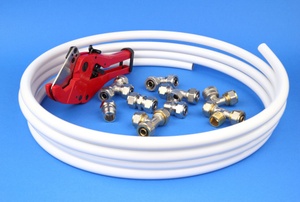 White piping with fittings on a blue surface.