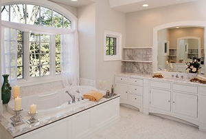 Custom white toned master bathroom with jacuzzi tub.