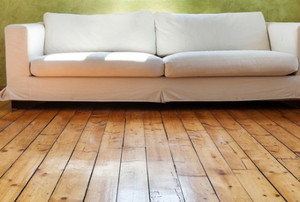 a reclaimed wood floor with a couch