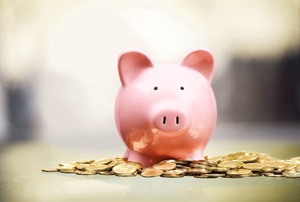 Piggy bank on top of pile of coins