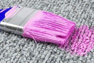 a carpet with a pink paintbrush on it