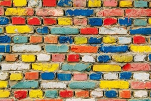 A wall of colorfully painted brick.