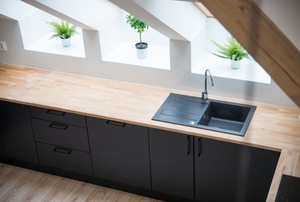 Black sink in long butcher block countertop