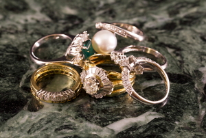 pile of various rings on marble surface