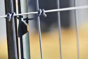 Close-up picture of wire running across a post on a T-post fence