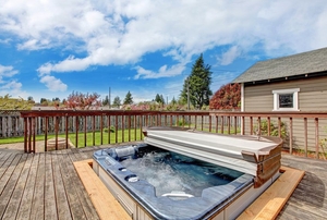 hot tub on a deck with cover folded back