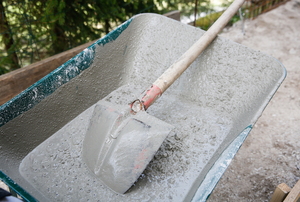 concrete and shovel in a wheelbarrow