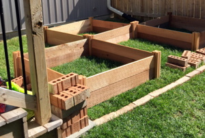 raised garden beds in construction in a backyard