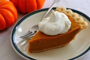 A slice of pumpkin pie on a plate.