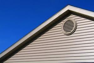 Exterior view of a gable vent with a blue sky in the background.
