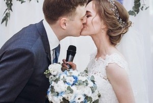 a husband and bride kiss at their wedding