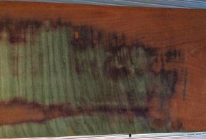 An oak veneer sanded off the surface of a table.