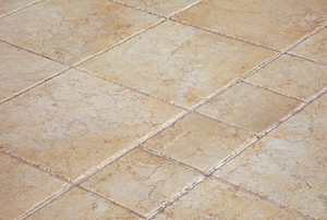A floor with large and small ceramic tiles.