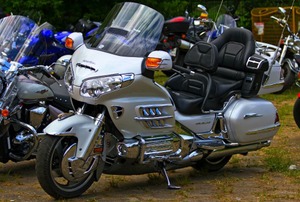 A silver Honda Goldwing in a motorcycle parking lot.