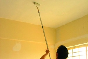 Painting a ceiling.
