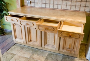 Set of wooden cabinets with open drawers
