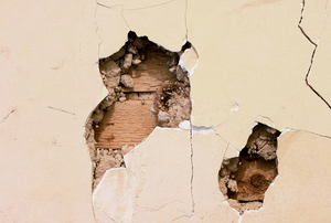 Two Holes in Plaster Wall