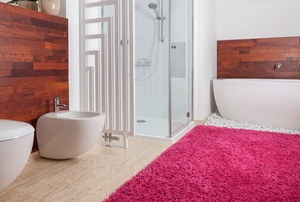 stylish bathroom with colorful rug and wood walls
