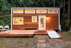 stylish wooden tiny home in a forest setting
