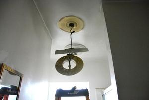A bath ceiling heater half uninstalled.