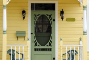 porch of yellow house with mint green front door