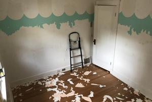 A room in an old house with peeling paint.