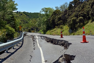 An earthquake splits a road.