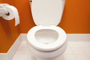 toilet with lid open in a bathroom
