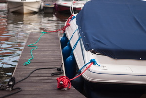 A boat tethered to a wooden dock