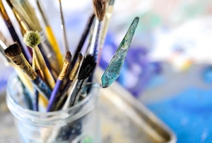 mason jar full of paintbrushes