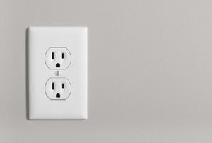 An outlet in a grey wall.